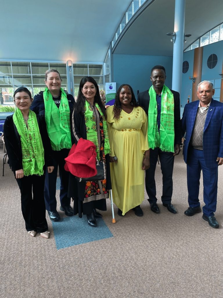 Group of six people stand together smiling at the camera. From the left they are: Support worker Emily, police officer Taryn Trevelion, Shadow Minister for Multicultural South Australia Jing Lee, JFA Purple Orange Project Officer Esther Simbi, Denis Yengi, and Mohan Bhattarai.