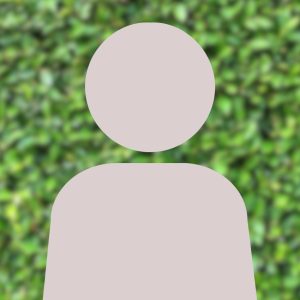 A grey person silhouette in front of blurred greenery.