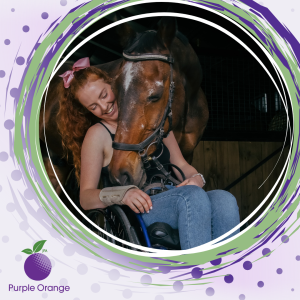 light purple background with spots. dark purple circle with dusty purple, light green and white swirling accents. Photo of Jessie sitting in her wheelchair with her horse, Storm, wrapping his head around her in a hug.